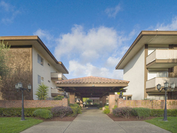 a walkway between two buildings with an awning